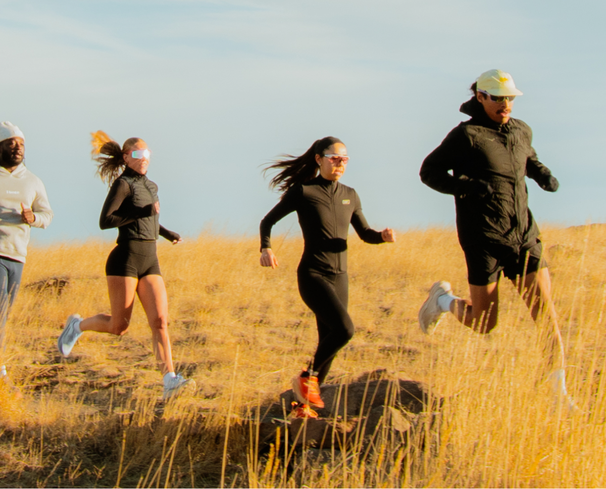 Friends running together on a sunny trail